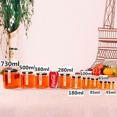 Bouteille de stockage en verre transparent hexagonal 100 ml 500 ml avec couvercle métallique pour la crème de miel
